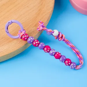 Handmade woven beaded keychain colorful charm bag pendant with rhinestones and metal ring.