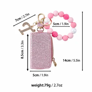 Monedero llavero de cuero con purpurina rosa y pulsera de cuentas de silicona con abalorio strás.