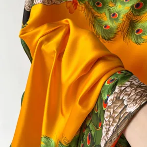 Detail view of summer Chinese style peacock print silk scarf, smooth and vibrant long drape.