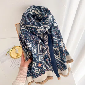 Detailed shot of winter geometric jacquard scarf with elegant tassels and warm fabric texture.