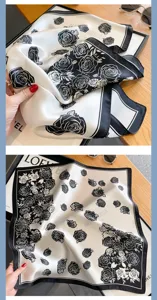 Silk square scarf with elegant black and white rose print, premium smooth fabric.