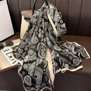Classic black and white paisley long silk scarf, elegant two-tone border drape main image.