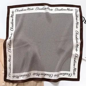 Silk square scarf featuring classic houndstooth pattern and elegant border typography.
