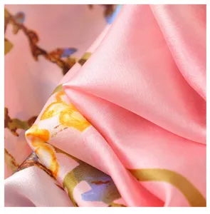Detailed view of pink silky scarf featuring a soft oil painting floral pattern and smooth texture.