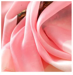 Detailed shot of a pink silk-feel scarf with oil painting print, showing smooth texture.