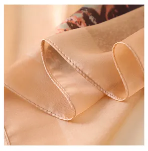 Close-up detail of the smooth imitation silk scarf showing delicate rolled hem and texture.