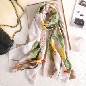 Silk feel long scarf with green leaf and fish print, elegant women wrap for daily wear.