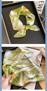 Foulard di seta dettaglio, strisce bianche verdi e stampa floreale primo piano.