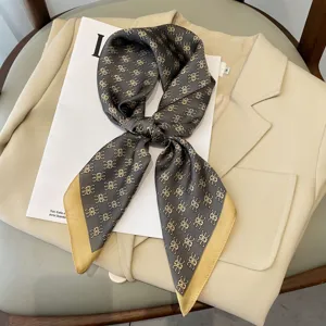 Chic silk scarf with elegant monogram pattern, perfect neckerchief or bag accessory for women.
