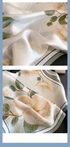 Silk scarf detail view showing elegant floral print, smooth texture and fine striped border.