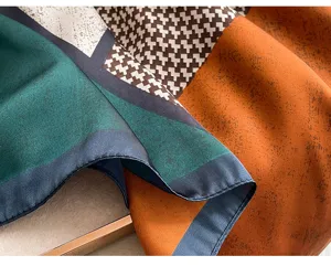Detailed view of women fashion colorblock silk scarf shawl, geometric houndstooth pattern.