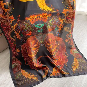 Detailed view of the luxurious baroque printed silk scarf showcasing intricate golden phoenix pattern.