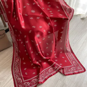 Detailed view of large red paisley silk scarf shawl, lightweight summer beach sun protection wrap.