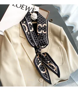 Chic black and white printed neck scarf with elegant camellia brooch accessory style.