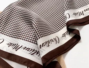 Brown houndstooth silk square scarf, elegant neckerchief detail showing fabric texture.