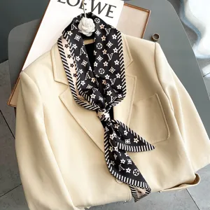 Fashion imitation silk neck scarf with classic monogram pattern and striped border, elegant detail.