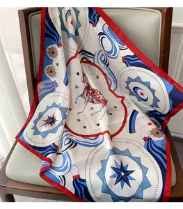 Close-up detail of luxury equestrian patterned silk square scarf draped on modern chair.