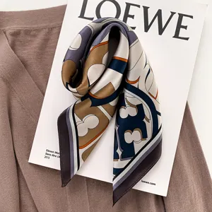 Elegant women's silk square scarf featuring chic geometric print, perfect stylish neck accessory.