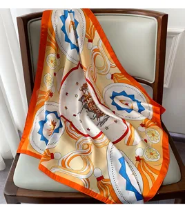 Close-up detail of the elegant printed silk square scarf showcasing classic equestrian motifs.