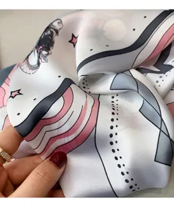 Close-up detail of silk feel square scarf with chic pink and grey abstract print design.