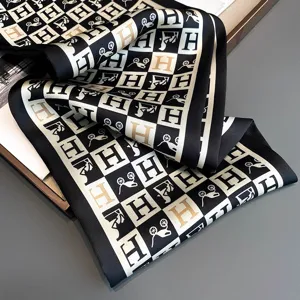 Chic black and gold silk satin neckerchief scarf, elegant geometric print fashion accessory.