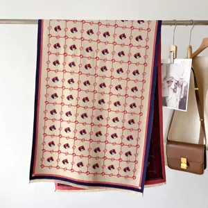 Luxurious cashmere feel winter scarf with elegant horse head grid pattern and fringe trim.