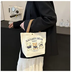 Detail view of the cute cartoon bear canvas shoulder bag, showing sturdy handles and premium fabric.