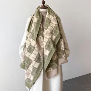 Detailed view of the double-sided printed plaid scarf featuring elegant equestrian horse motifs.