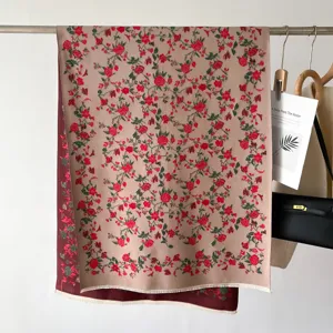 Detailed shot of an elegant vintage floral printed imitation cashmere scarf hanging on a rack.