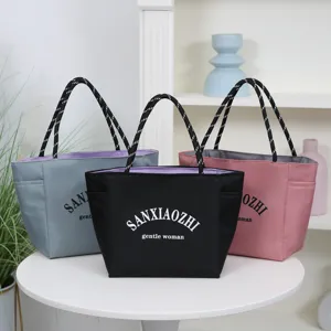 Fashionable waterproof canvas tote bag with large capacity, perfect for daily casual commuting.