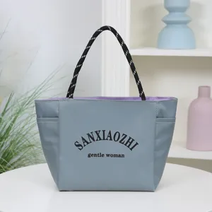Stylish grey waterproof canvas tote bag with rope handles and large capacity for daily commute.