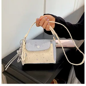 Chic star pattern color-matching crossbody handbag with cute charm detail, perfect for daily wear.