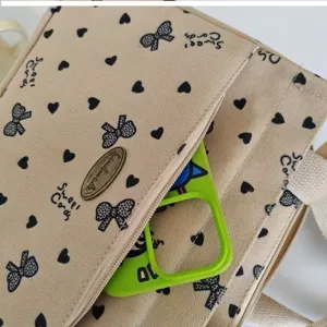 Canvas handbag with cute heart and bow print, large capacity commuter bento bag for daily use.
