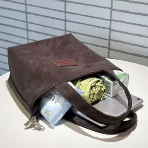 Detail view of the brown PU leather minimalist handbag, showcasing large capacity interior.