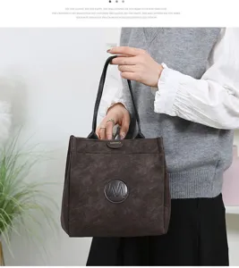 Detailed view of stylish women tote bag with textured finish, double handles and elegant logo.