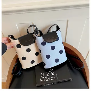 Casual polka dot linen bucket shoulder bag with contrast leather flap and stylish design.