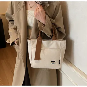 Detailed view of Japanese style canvas tote bag with embroidery, chic casual shoulder bag.