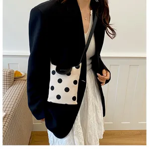 Chic polka dot linen patchwork shoulder bag, casual style design with black flap and strap.