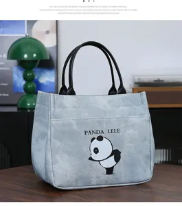 Detail view of the stylish blue pu leather tote bag featuring a cute cartoon panda print.