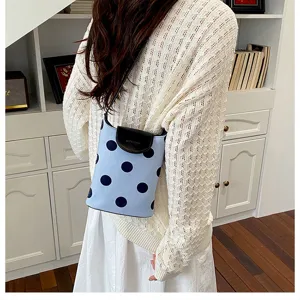 Blue polka dot shoulder bag with black flap, stylish canvas bucket bag for women daily use.