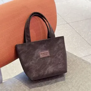 Detail shot of the dark brown PU leather tote bag, showcasing texture and daily design.