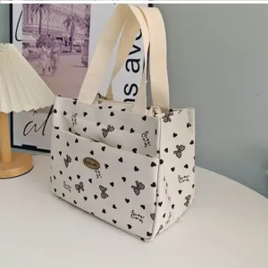 Canvas lunch tote bag with cute bow and heart print, perfect for daily commuting work.