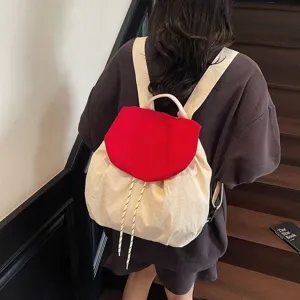 Korean style nylon backpack detail showing contrast color flap design and adjustable canvas straps.