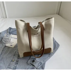 Casual canvas tote bag with brown leather handles, stylish Korean style daily commuting shoulder bag.