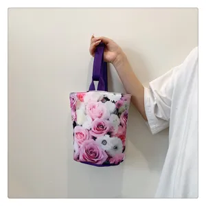 Canvas bucket handbag with floral rose print, portable lunch bag for women daily use.