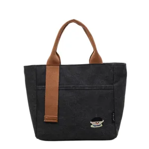 Black thickened canvas tote bag with brown handles, casual commuter handbag with embroidery.
