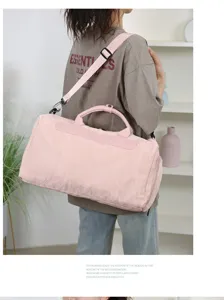 Detail view of pink PU travel duffel bag, large capacity gym bag with wet dry separation.