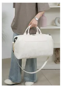 Large capacity white PU travel duffel bag with shoulder strap, lightweight waterproof gym bag.
