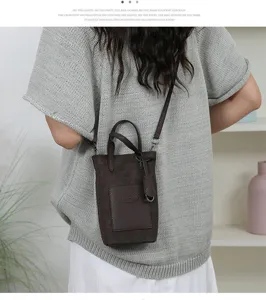 Classic brown mini bucket bag for women, stylish leather crossbody bag with handle and strap.