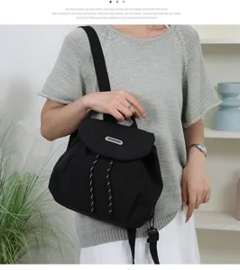 Casual black canvas drawstring backpack for women, lightweight daily school bookbag.
